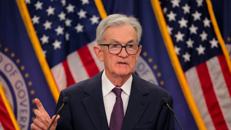 Fed Cuts Interest Rate by 0.25% Amid Market Uncertainty Federal Reserve building with digital overlay symbolizing interest rate decisions and market volatility